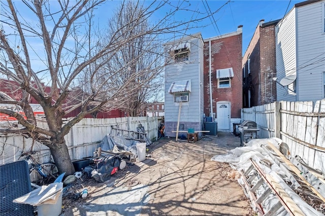 rear view of house featuring brick siding, a patio area, and a fenced backyard