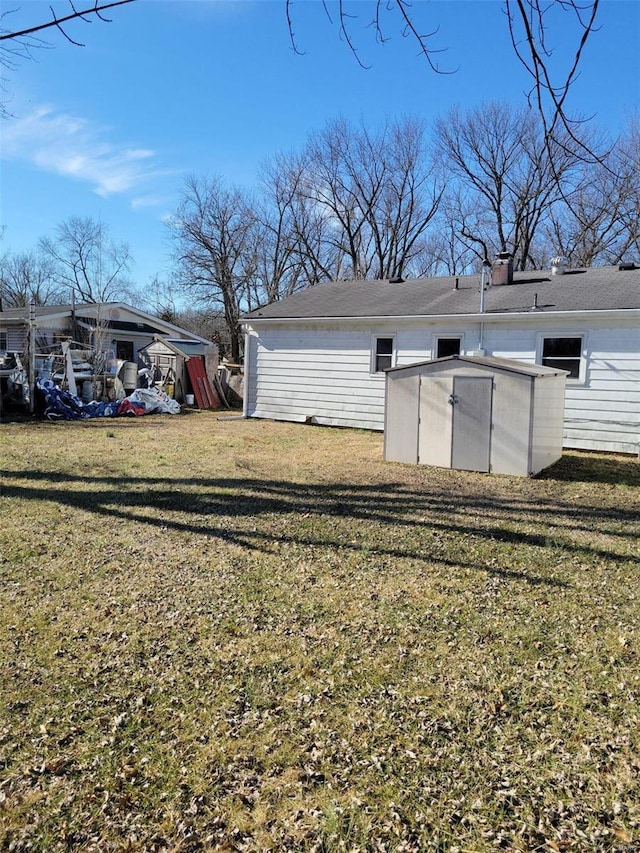 view of yard featuring an outbuilding and a storage unit