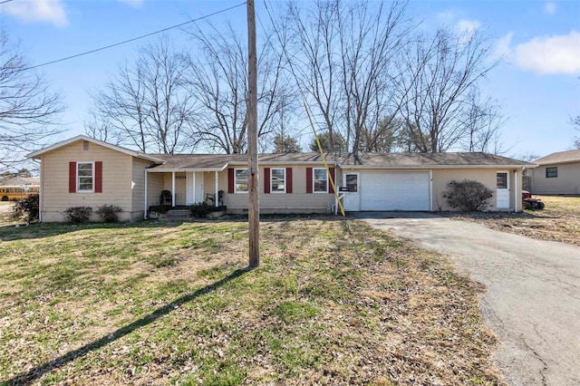 ranch-style house featuring a front yard, an attached garage, covered porch, and driveway