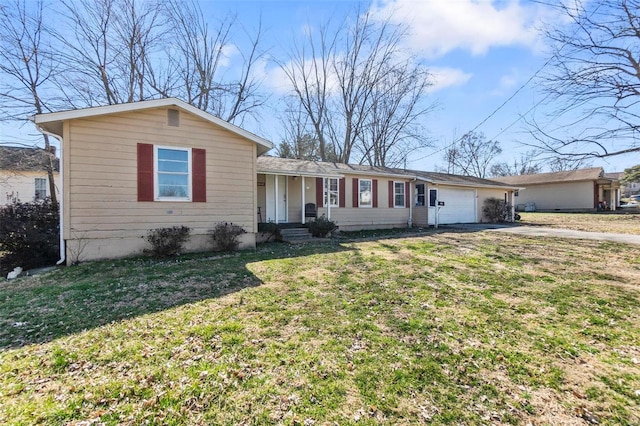 ranch-style house featuring driveway, a front yard, and an attached garage