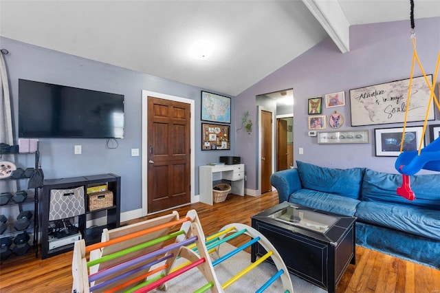 living room featuring lofted ceiling with beams, baseboards, and wood finished floors