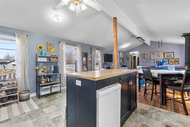 kitchen featuring butcher block countertops, open floor plan, a center island, ceiling fan, and vaulted ceiling with beams