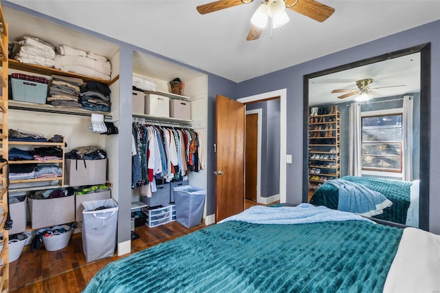 bedroom featuring ceiling fan, a closet, baseboards, and wood finished floors