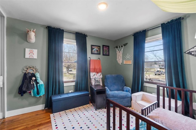 bedroom with baseboards and wood finished floors