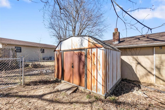 view of shed featuring fence