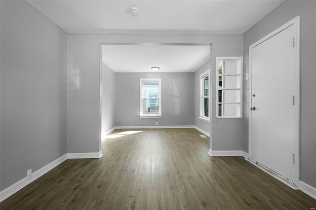 foyer entrance featuring dark wood-style floors and baseboards