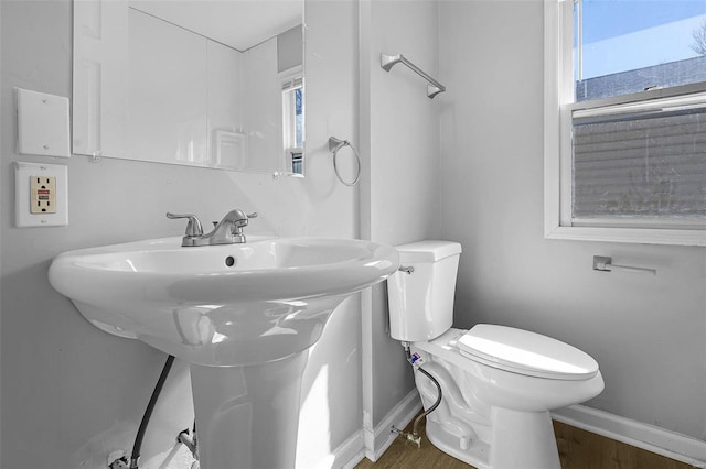 bathroom featuring baseboards, toilet, and wood finished floors