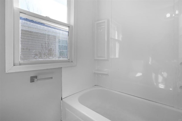 bathroom featuring a bath and a shower