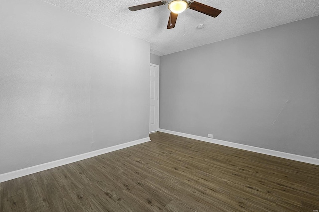 unfurnished room with a textured ceiling, dark wood-style floors, baseboards, and ceiling fan
