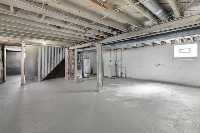 below grade area featuring stairs, washer / clothes dryer, and water heater