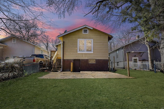 rear view of house with a patio area, a lawn, stairs, and a fenced backyard