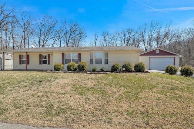 ranch-style house with a garage, an outbuilding, and a front lawn