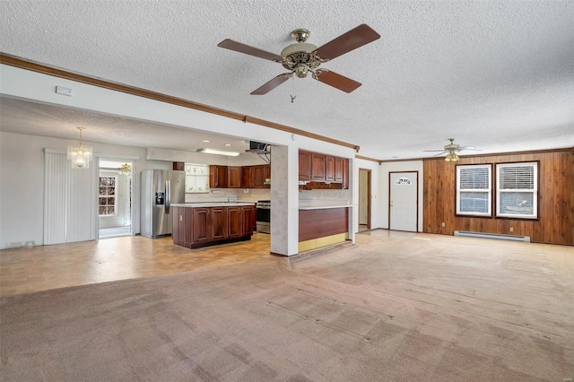 unfurnished living room featuring light colored carpet, baseboard heating, crown molding, and a textured ceiling