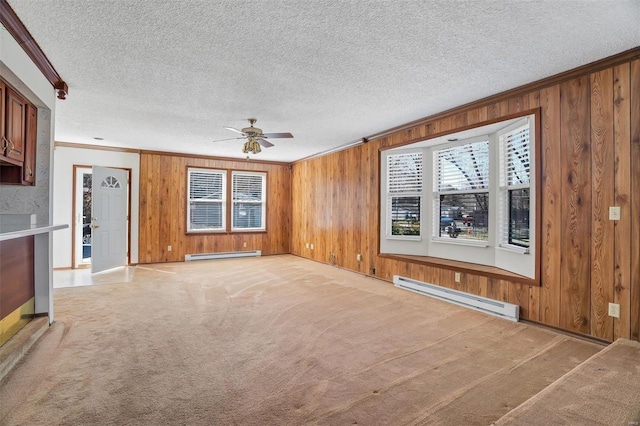 unfurnished living room with light carpet, wooden walls, and a baseboard radiator