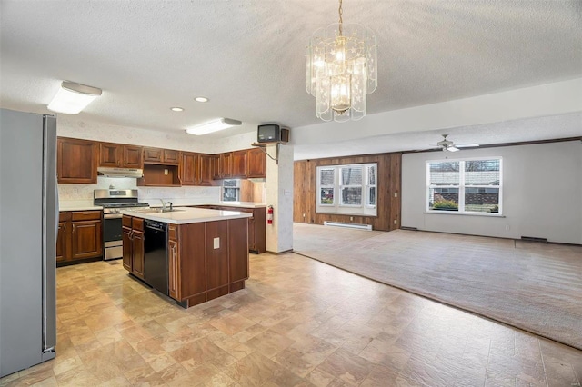 kitchen with light carpet, under cabinet range hood, a kitchen island, appliances with stainless steel finishes, and light countertops