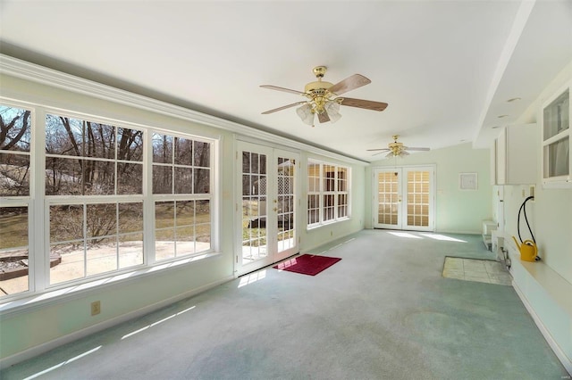 unfurnished sunroom with french doors and a ceiling fan