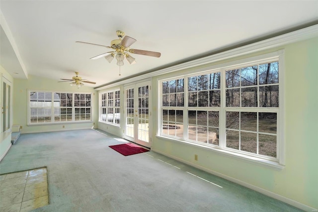 unfurnished sunroom featuring a ceiling fan