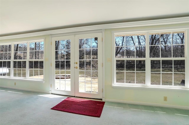 entryway featuring french doors, baseboards, and carpet floors