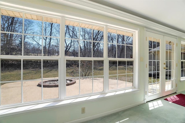 entryway featuring french doors and carpet