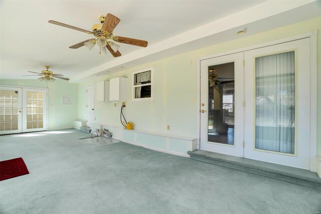 interior space featuring french doors, carpet floors, and ceiling fan