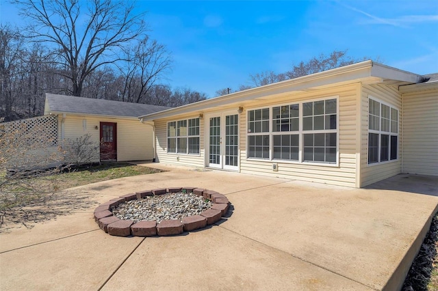 back of house featuring a patio area, french doors, and an outdoor fire pit