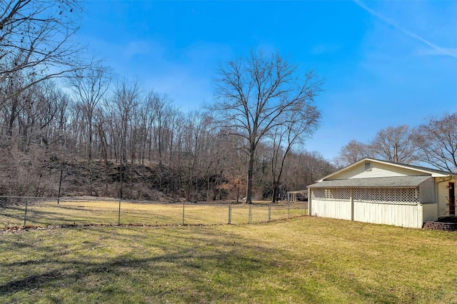 view of yard featuring a pole building, an outdoor structure, and fence