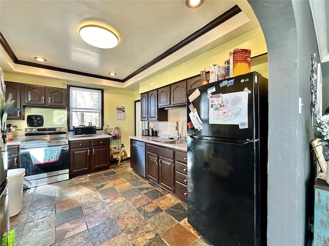 kitchen with a tray ceiling, dark brown cabinets, appliances with stainless steel finishes, and a sink