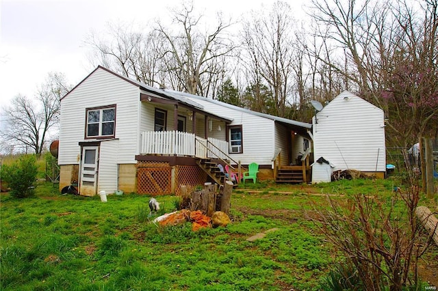 back of property featuring stairway and covered porch