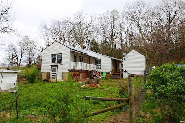 back of house with stairs