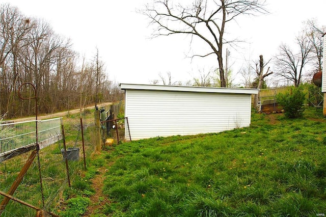 view of outbuilding featuring an outdoor structure and fence