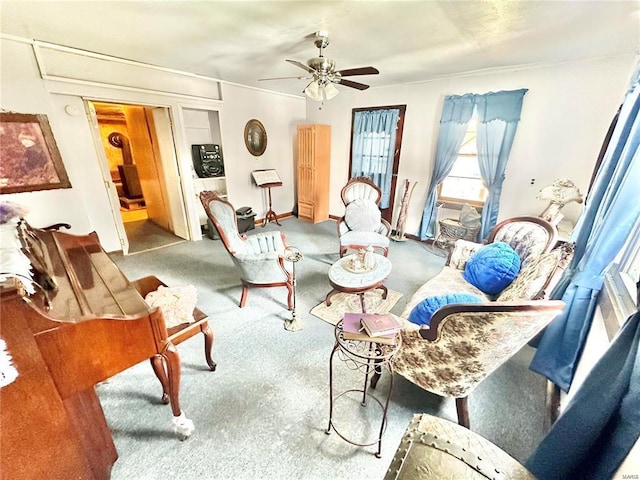 living area with ceiling fan and carpet floors