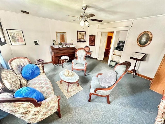 carpeted living area featuring baseboards and ceiling fan