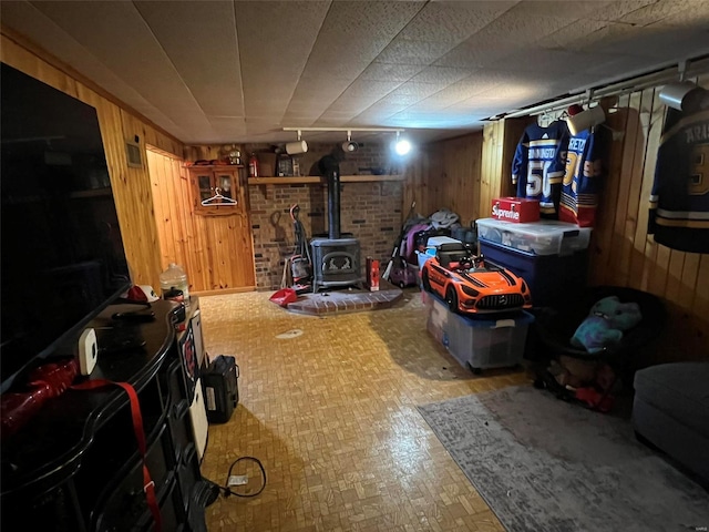 finished below grade area with wood walls and a wood stove