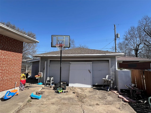 garage with driveway and fence