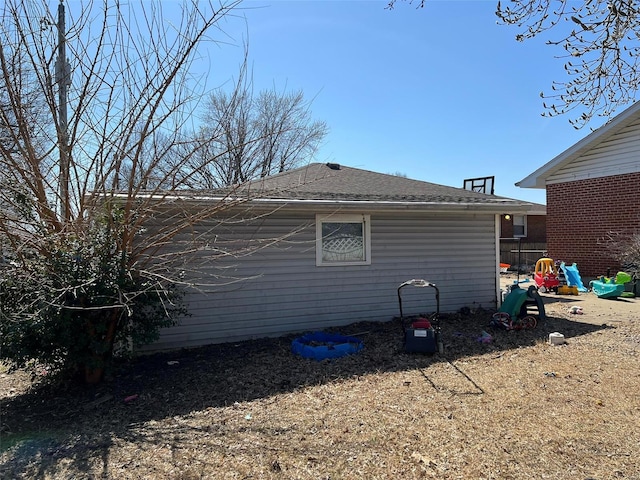 view of property exterior featuring roof with shingles