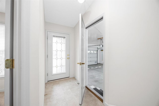 doorway with visible vents and baseboards