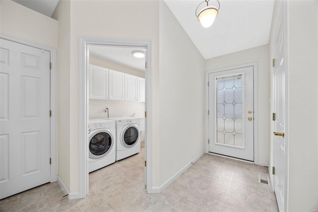 laundry area with baseboards, cabinet space, visible vents, and washer and clothes dryer