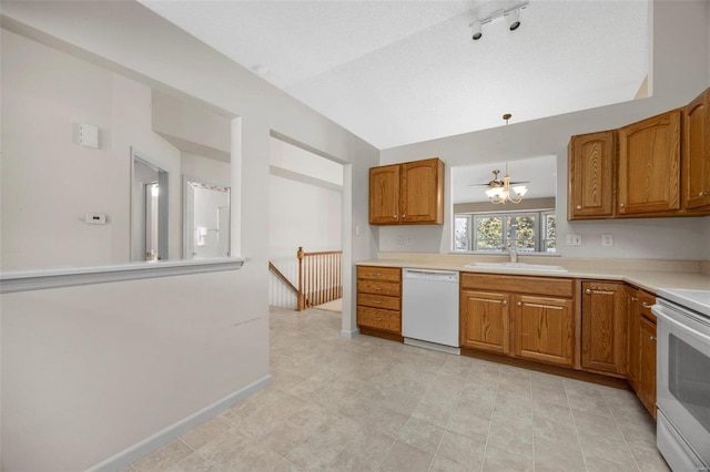 kitchen featuring baseboards, light countertops, brown cabinetry, white appliances, and a sink