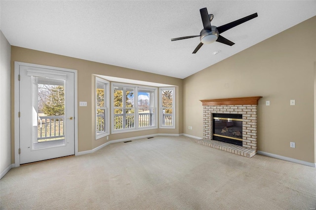 unfurnished living room with visible vents, baseboards, carpet flooring, lofted ceiling, and ceiling fan