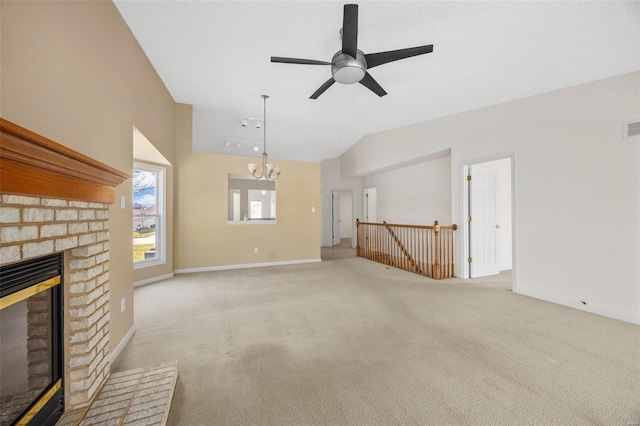 unfurnished living room featuring visible vents, vaulted ceiling, a brick fireplace, carpet flooring, and ceiling fan with notable chandelier