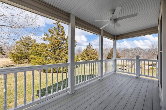 deck featuring a yard and a ceiling fan