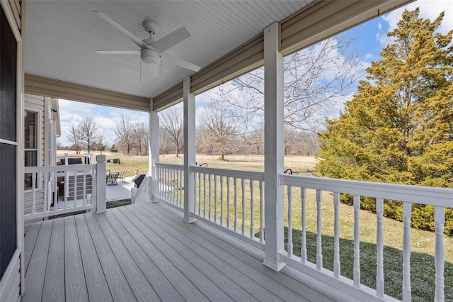 deck featuring a yard and a ceiling fan