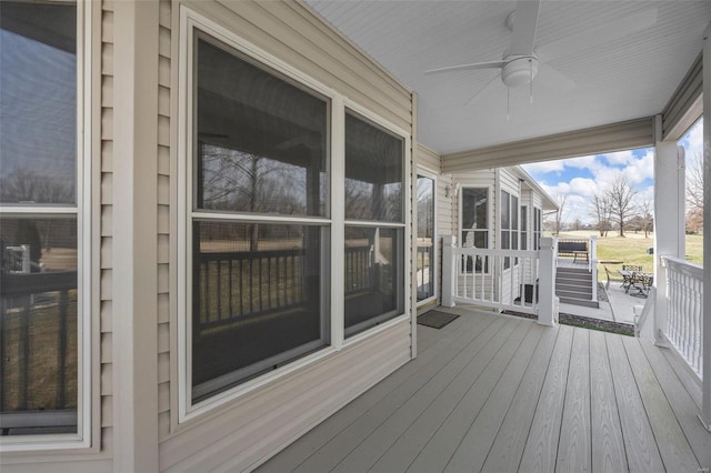 wooden terrace featuring a ceiling fan