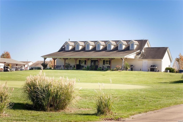 cape cod home featuring a front yard