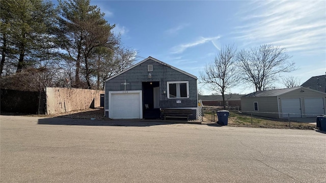 detached garage featuring fence