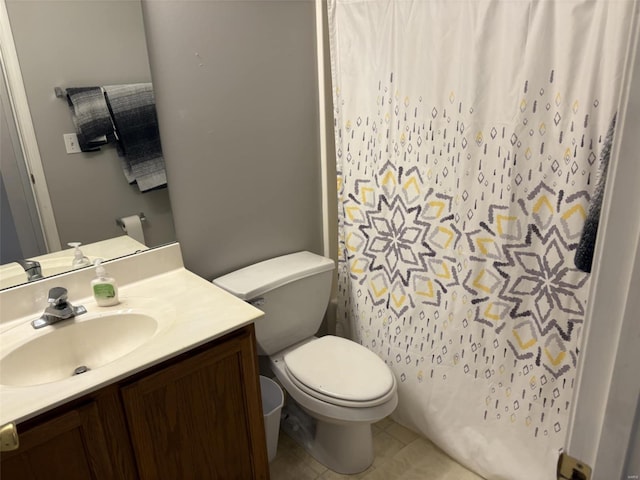 bathroom featuring a shower with shower curtain, toilet, vanity, and tile patterned floors