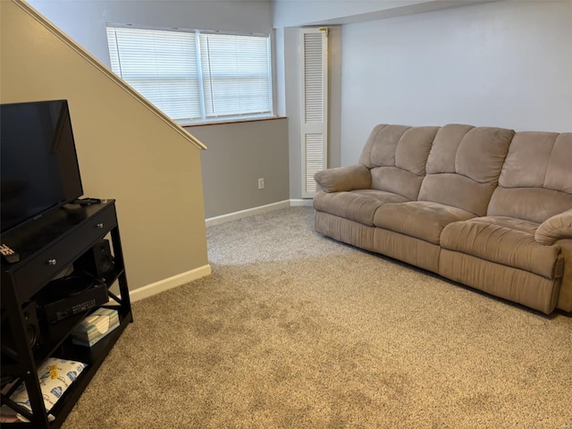 carpeted living room featuring baseboards