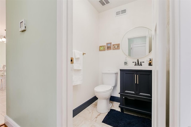 half bath with visible vents, baseboards, toilet, and marble finish floor