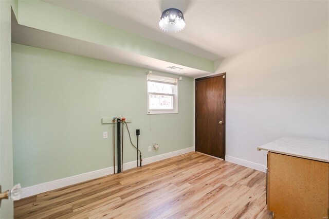 interior space with visible vents, baseboards, and light wood-type flooring