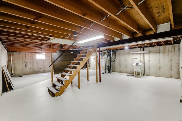 basement with stairway and water heater